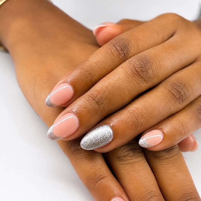 Nude gel · silver glitter french — nails by Ezra's Nail Studio, Aluva